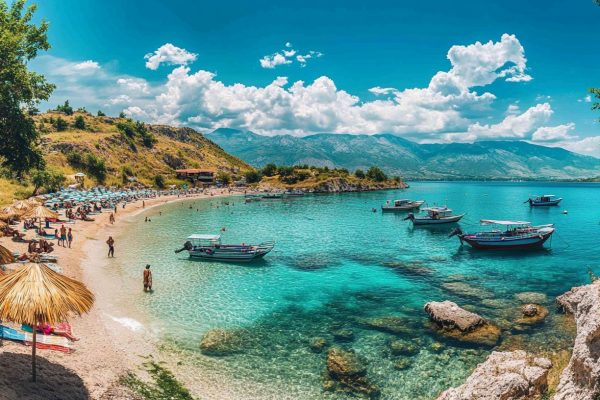 A high-resolution stunning landscape photography of the most beautiful beach in Kasmil, Albania, at midday. with vivid shimering crystal-clear turquoise water and blue skies with a few white bright clouds, Shot from an elevated angle. on the beach straw umbrellas hosts relaxed people socializing and watching colorful boats arrive at the port. Vibrant, Eye-catching, energetic color palatte, of a vacation destination. --chaos 5 --ar 16:9 --stylize 200 --v 6.1 Job ID: 4346adc8-2206-4aeb-8d2e-3c2304236689